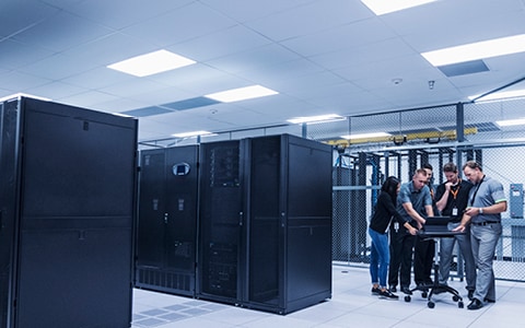 Server room with technology professionals 